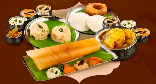 Traditional South Indian breakfast served with chutneys and accompaniments