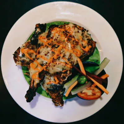 Grilled fish fillet served with sautéed vegetables