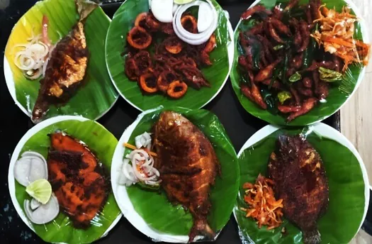 Assorted Hotel CAPS dishes served on banana leaves