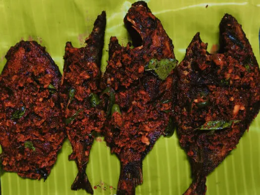Spicy fried fish pieces served on a banana leaf