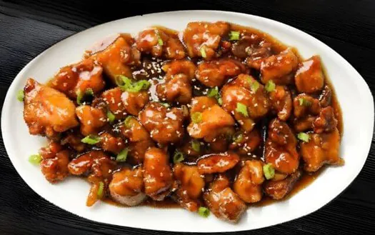 Indo-Chinese chicken appetizer garnished with spring onions