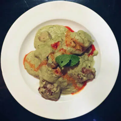 Creamy chicken curry served with vegetables and herbs