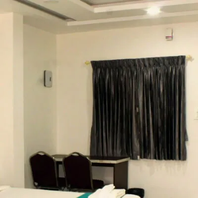 Hotel CAPS room with air conditioning, window and seating area